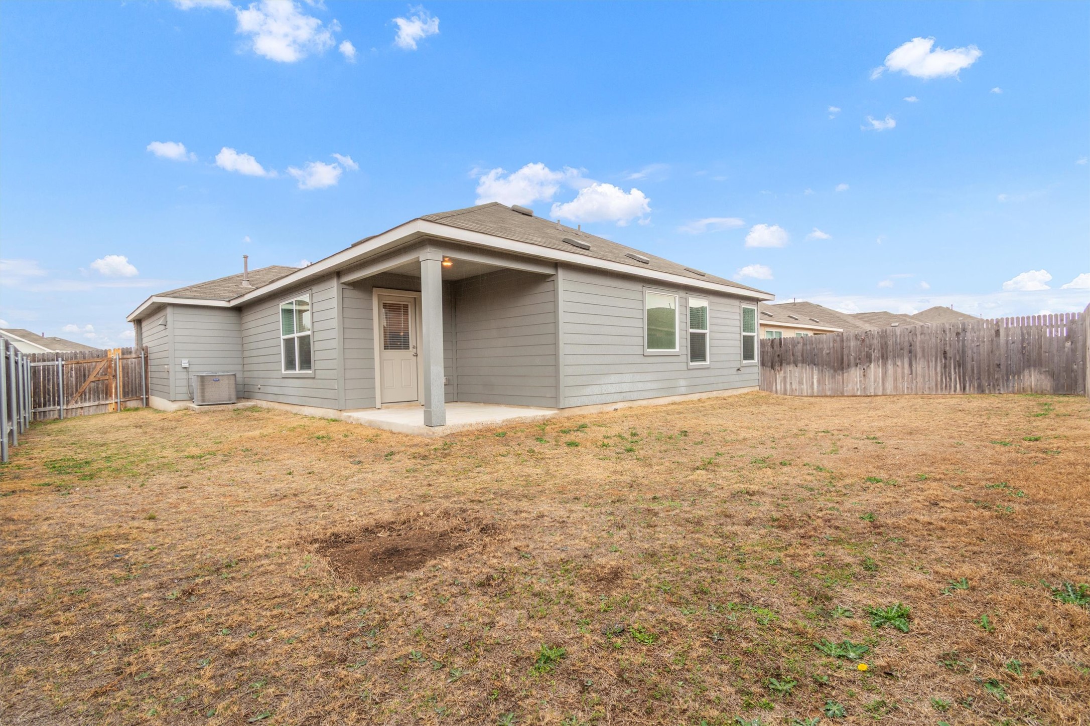 301 Blue Springs Pass Kyle, TX 78640 - Photo 19 of 20 Rear view of house featuring a patio and a fenced backyard