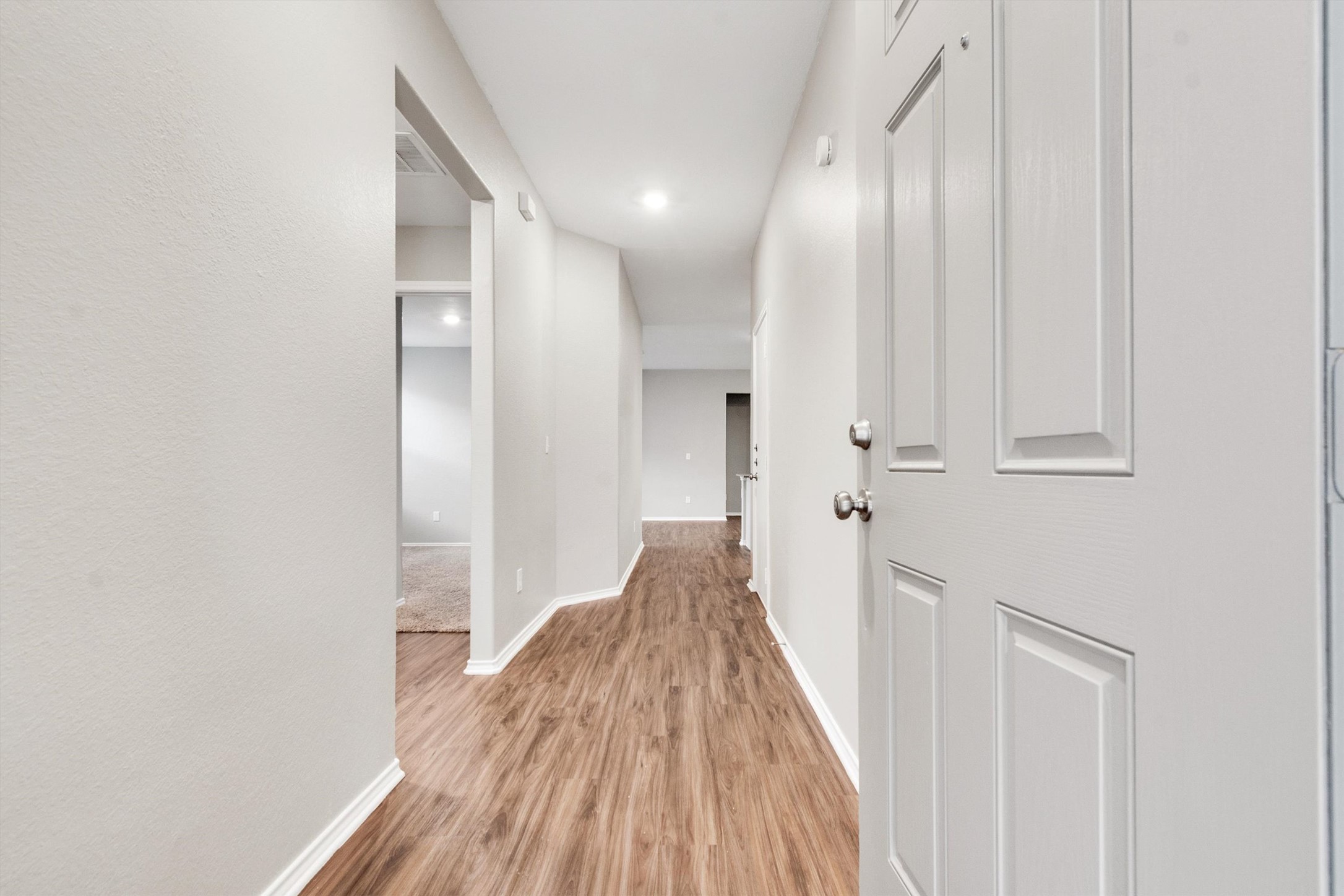 301 Blue Springs Pass Kyle, TX 78640 - Photo 3 of 20 Hall with baseboards and light wood finished floors