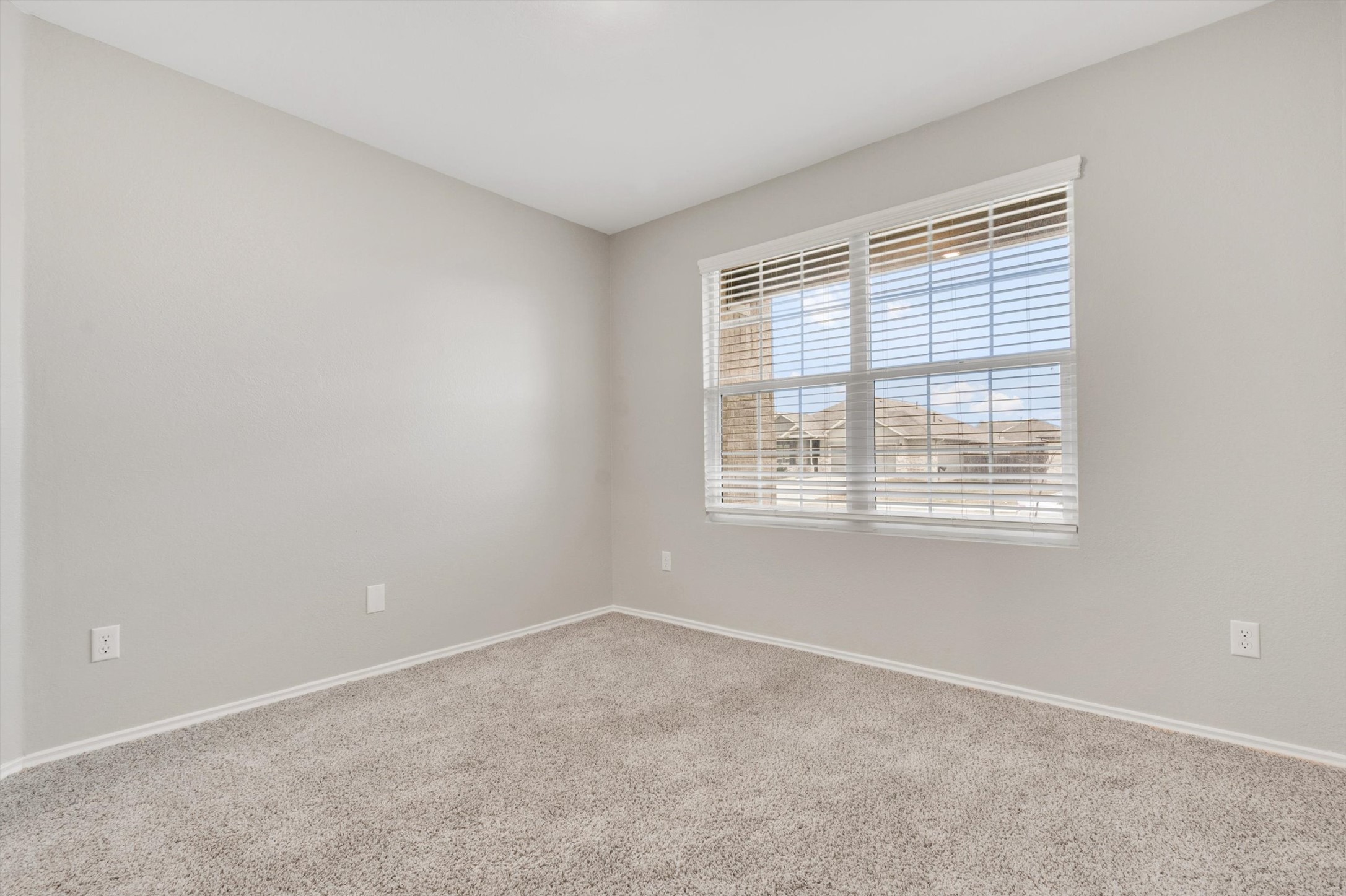 301 Blue Springs Pass Kyle, TX 78640 - Photo 6 of 20 Empty room featuring carpet and baseboards