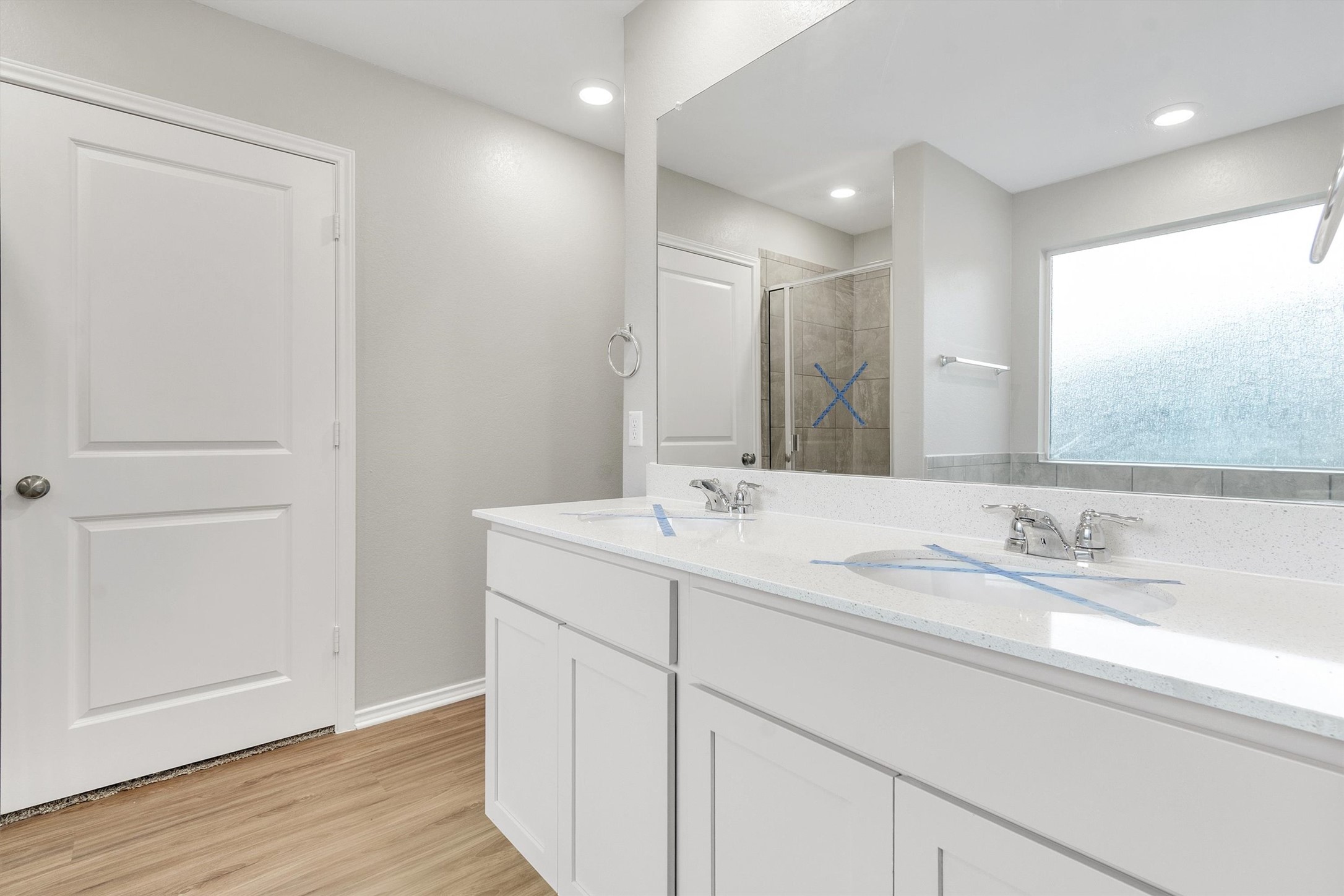 301 Blue Springs Pass Kyle, TX 78640 - Photo 8 of 20 Full bathroom featuring a shower stall, double vanity, and light wood-style floors