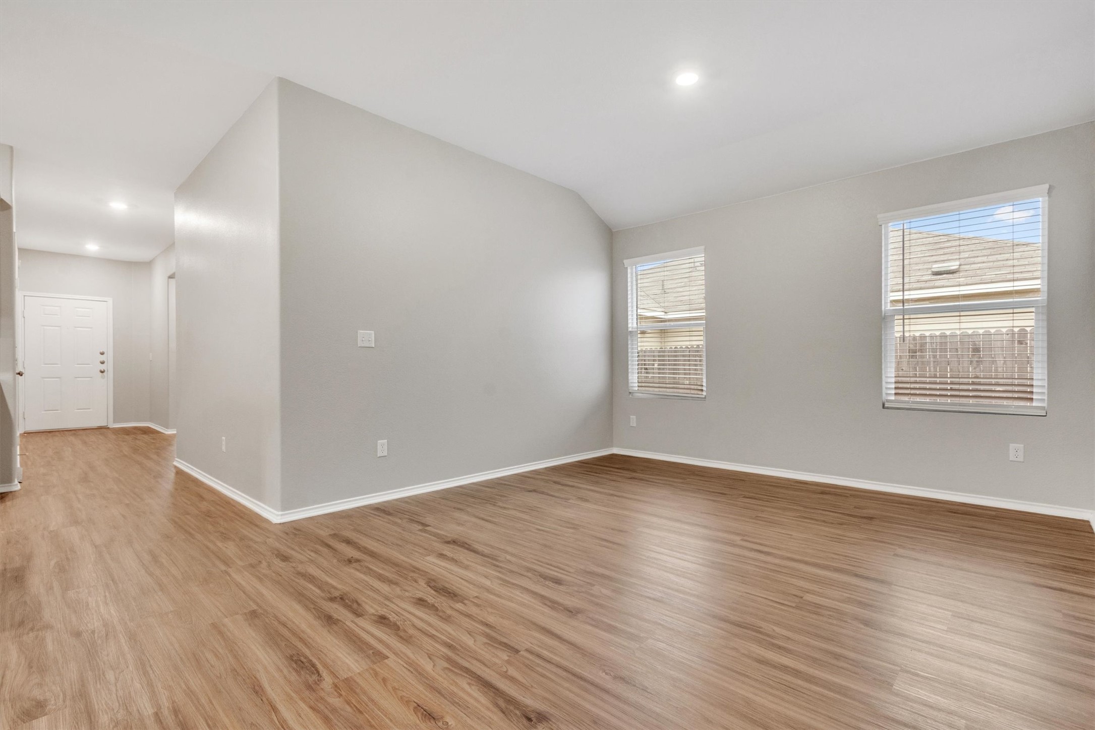 301 Blue Springs Pass Kyle, TX 78640 - Photo 10 of 20 Spare room with light wood finished floors, lofted ceiling, and recessed lighting