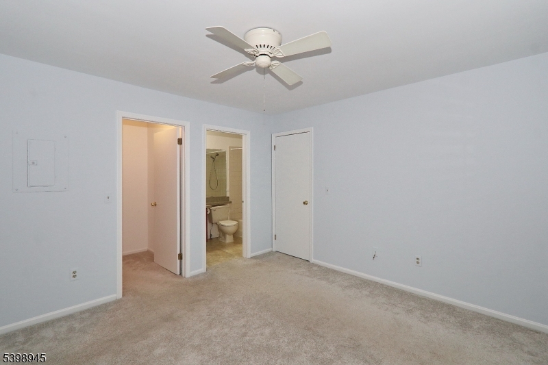 21 Parkside Road Bedminster, NJ 07921 - Photo 13 of 17 an empty room with closet and ceiling fan