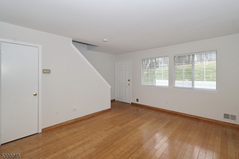 21 Parkside Road Bedminster, NJ 07921 - Photo 7 of 17 an empty room with wooden floor and windows