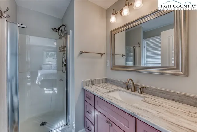 a bathroom with a granite countertop sink mirror and double