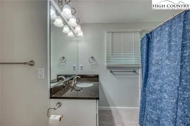 a bathroom with a sink a mirror and shower