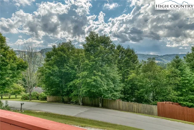 a view of a house with a yard and potted plants