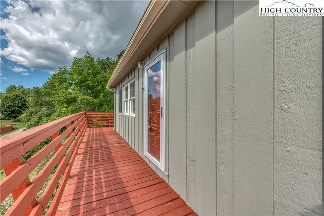 a view of balcony with wooden floor and fence