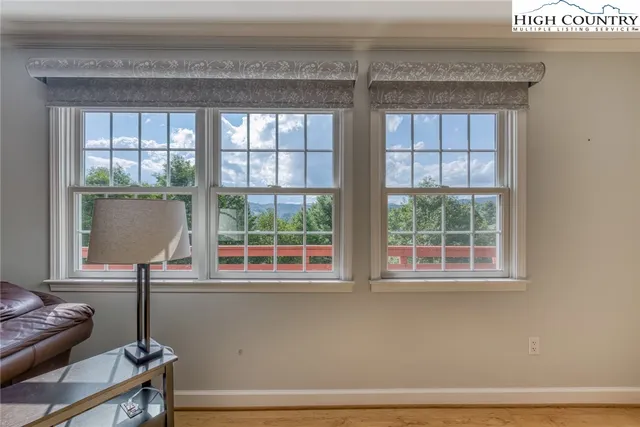 a living room with a chair and a window