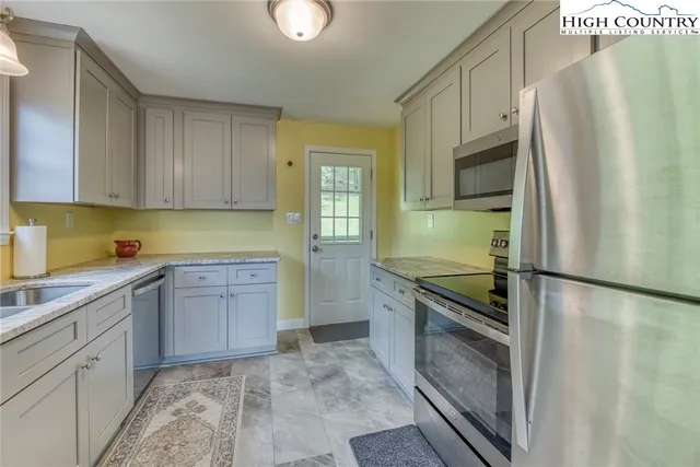 a kitchen with a refrigerator sink and stove