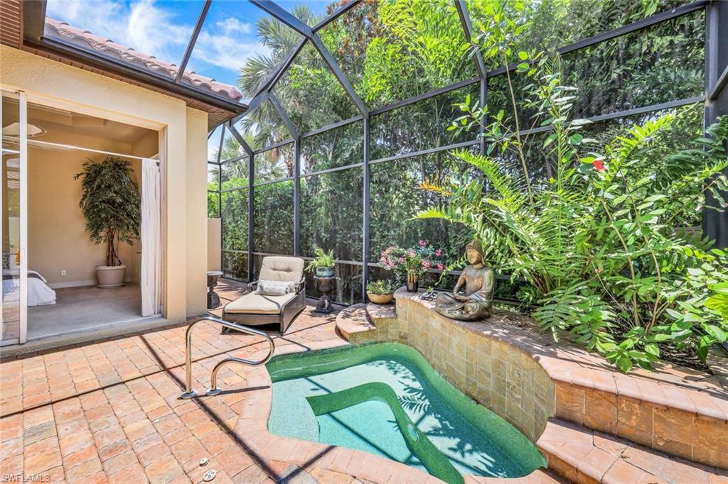5797 Mango Circle, Unit 5797 Naples, FL 34110 - Photo 15 of 22 a view of a chairs and table in a patio