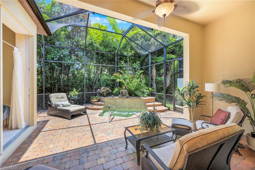 5797 Mango Circle, Unit 5797 Naples, FL 34110 - Photo 21 of 22 a view of a patio with couches chairs and potted plants
