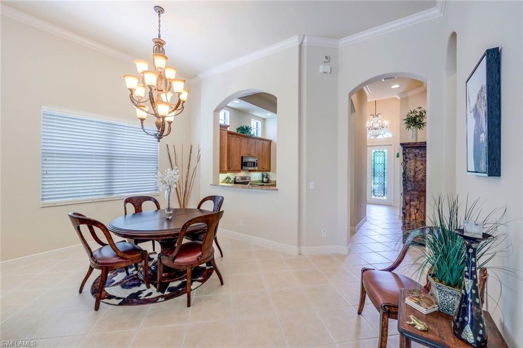 5797 Mango Circle, Unit 5797 Naples, FL 34110 - Photo 6 of 22 a view of a dining room with furniture and chandelier