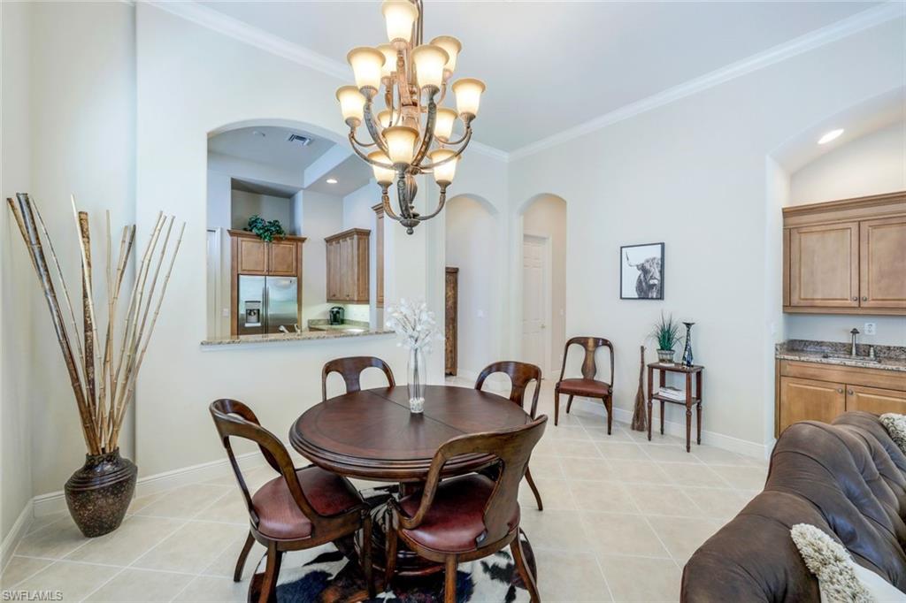 5797 Mango Circle, Unit 5797 Naples, FL 34110 - Photo 7 of 22 a view of a dining room with furniture window and wooden floor