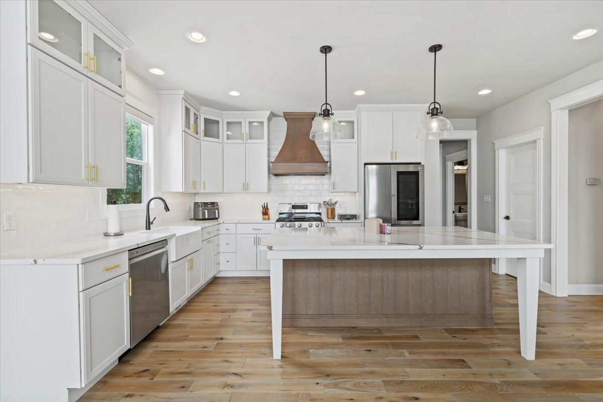 12893 Baker Court Crown Point, IN 46307 - Photo 12 of 52 a kitchen with stainless steel appliances granite countertop a sink stove and refrigerator