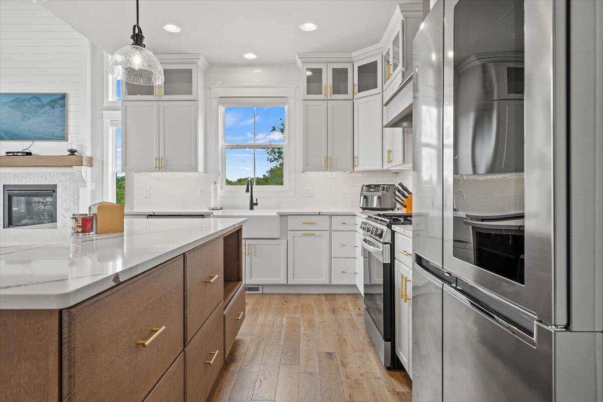 12893 Baker Court Crown Point, IN 46307 - Photo 14 of 52 a kitchen with a sink stainless steel appliances and white cabinets