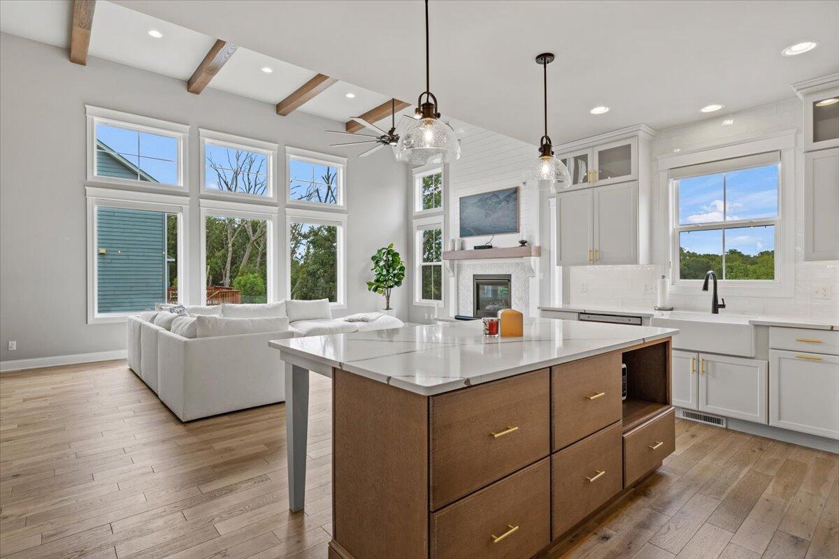 12893 Baker Court Crown Point, IN 46307 - Photo 16 of 52 a kitchen with sink stove and white cabinets with wooden floor