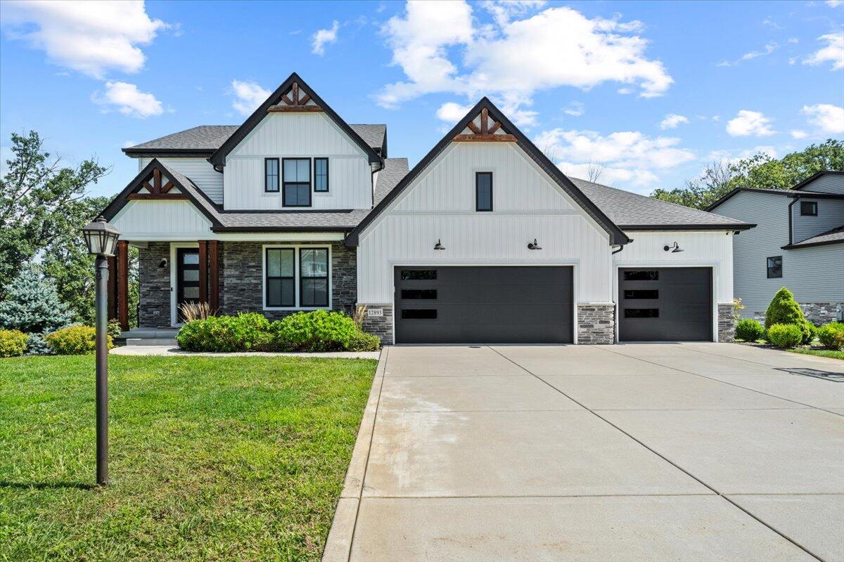 12893 Baker Court Crown Point, IN 46307 - Photo 2 of 52 a front view of a house with a yard and garage
