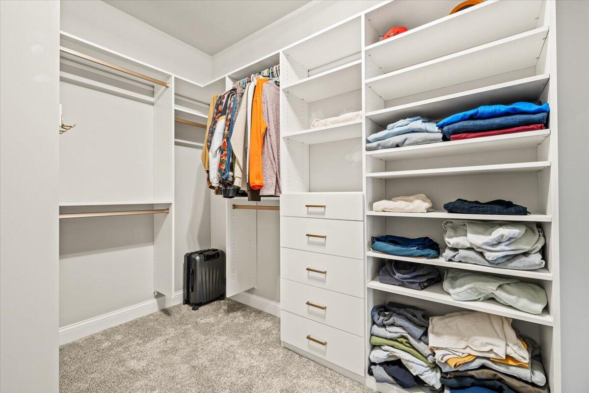 12893 Baker Court Crown Point, IN 46307 - Photo 23 of 52 a view of walk in closet with clothes and shoes