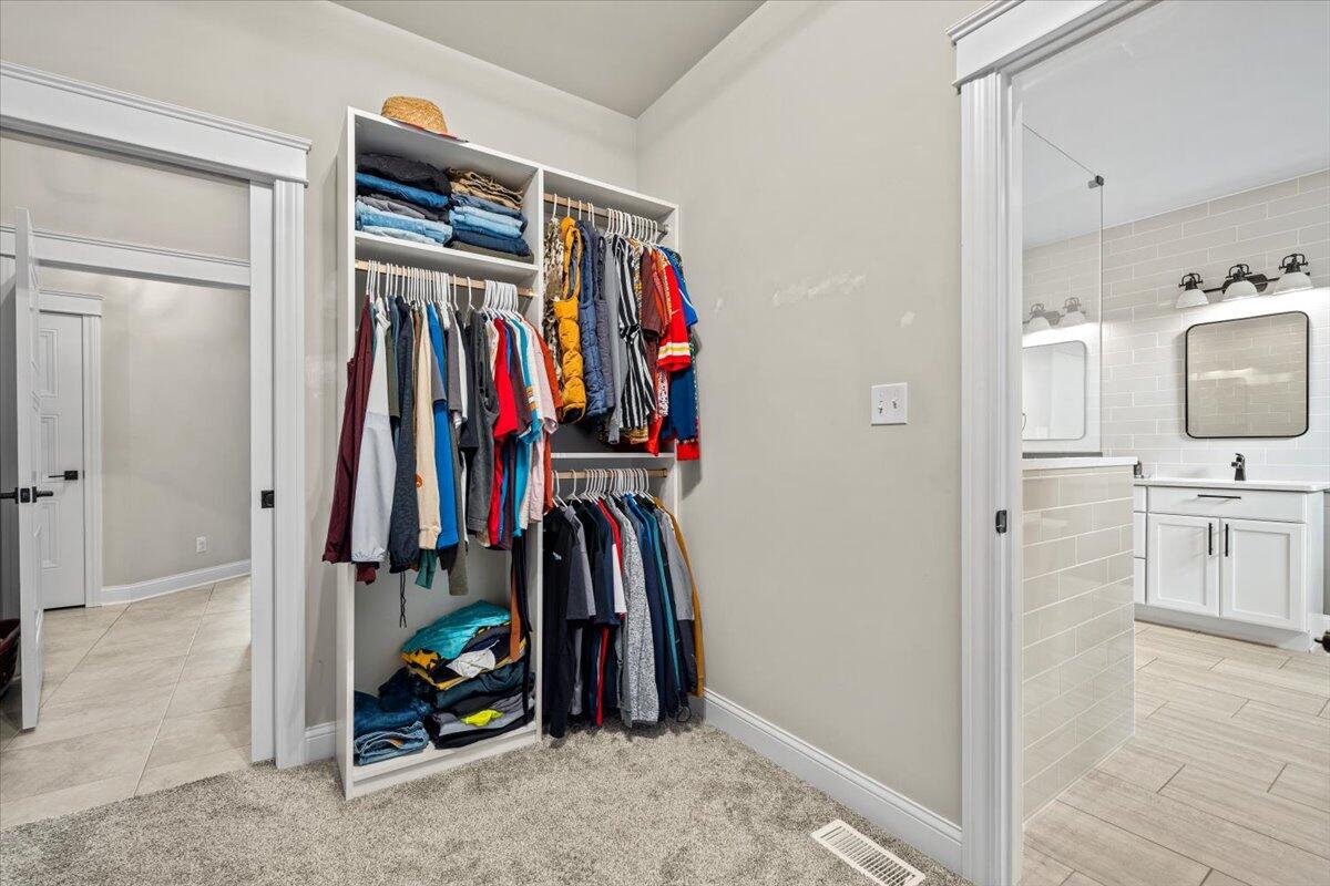 12893 Baker Court Crown Point, IN 46307 - Photo 24 of 52 a view of walk in closet with clothes and shoes