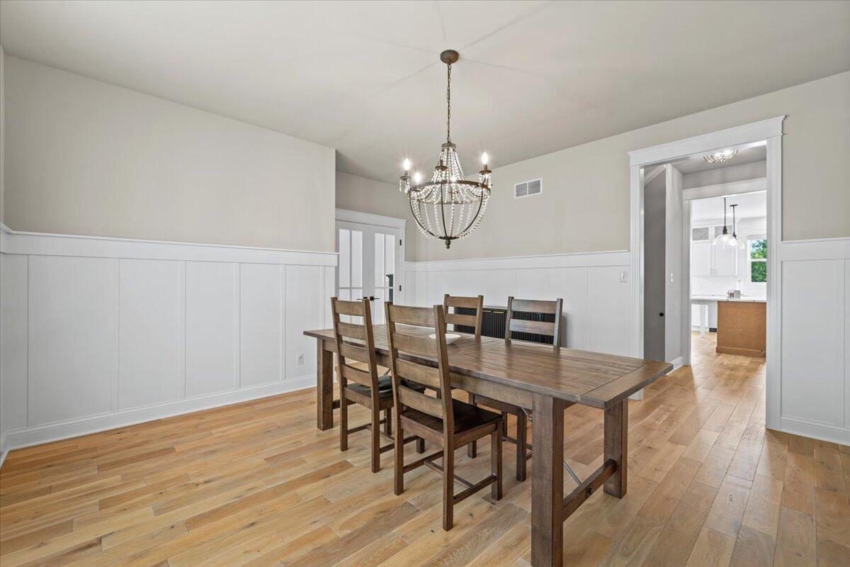 12893 Baker Court Crown Point, IN 46307 - Photo 8 of 52 a view of a dining room with furniture and wooden floor