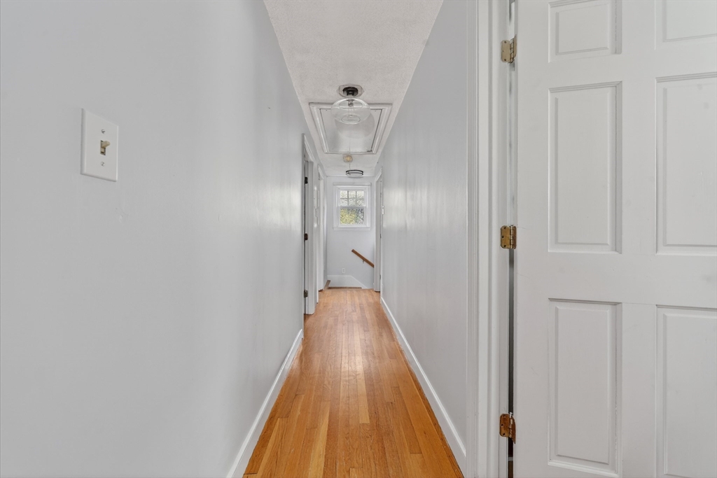 59 First Parish Road Norwell, MA 02061 - Photo 19 of 37 a view of a hallway with wooden floor and staircase