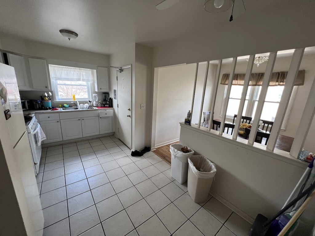 568 Ida Court Mount Prospect, IL 60056 - Photo 14 of 25 a kitchen with a refrigerator and white cabinets
