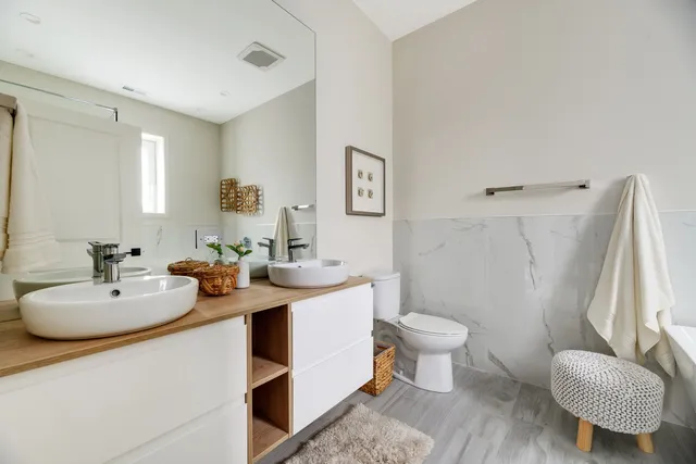 a bathroom with a sink toilet and a mirror