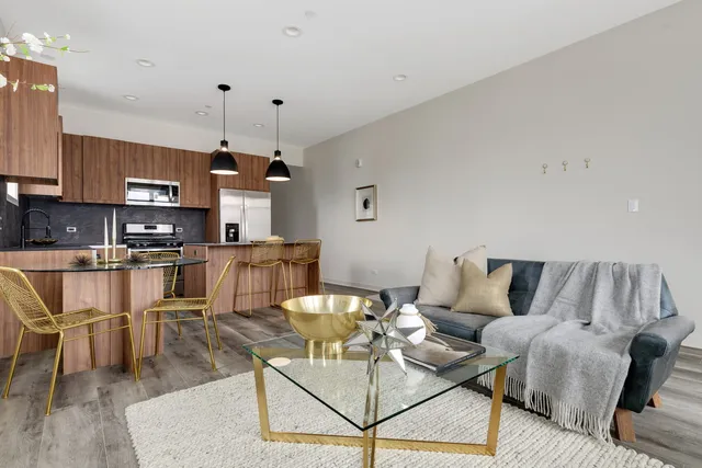 a living room with furniture and kitchen view
