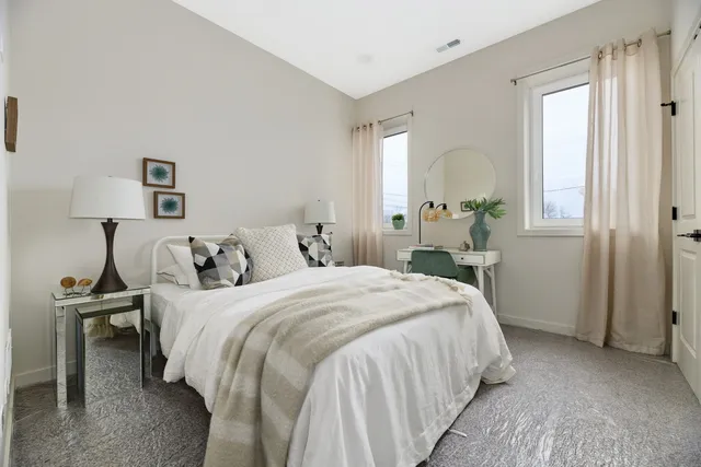 a bedroom with a bed and a lamp