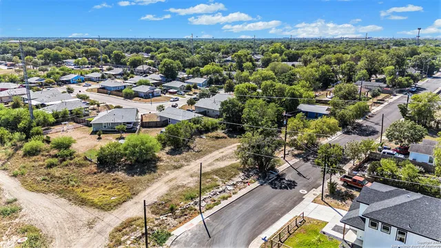 an aerial view of residential houses with outdoor space and seating