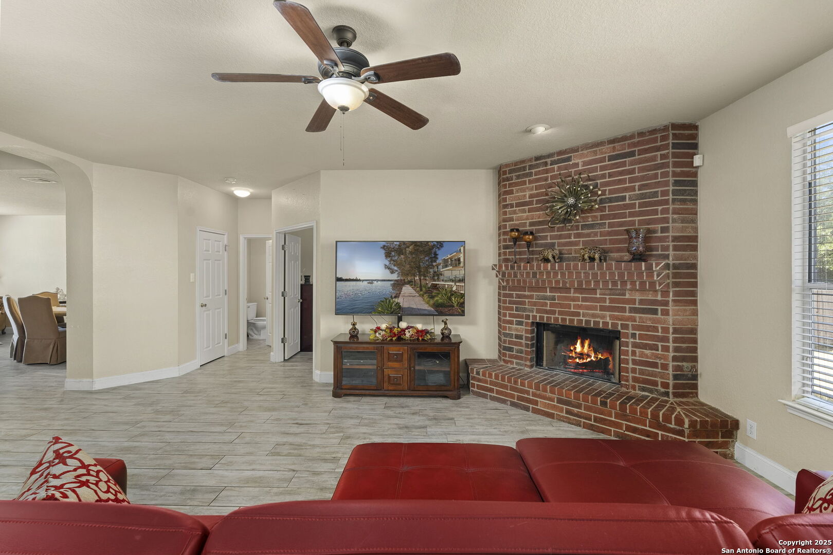 8747 Feather Trail Helotes, TX 78023 - Photo 13 of 34 a living room with furniture fireplace and flat screen tv