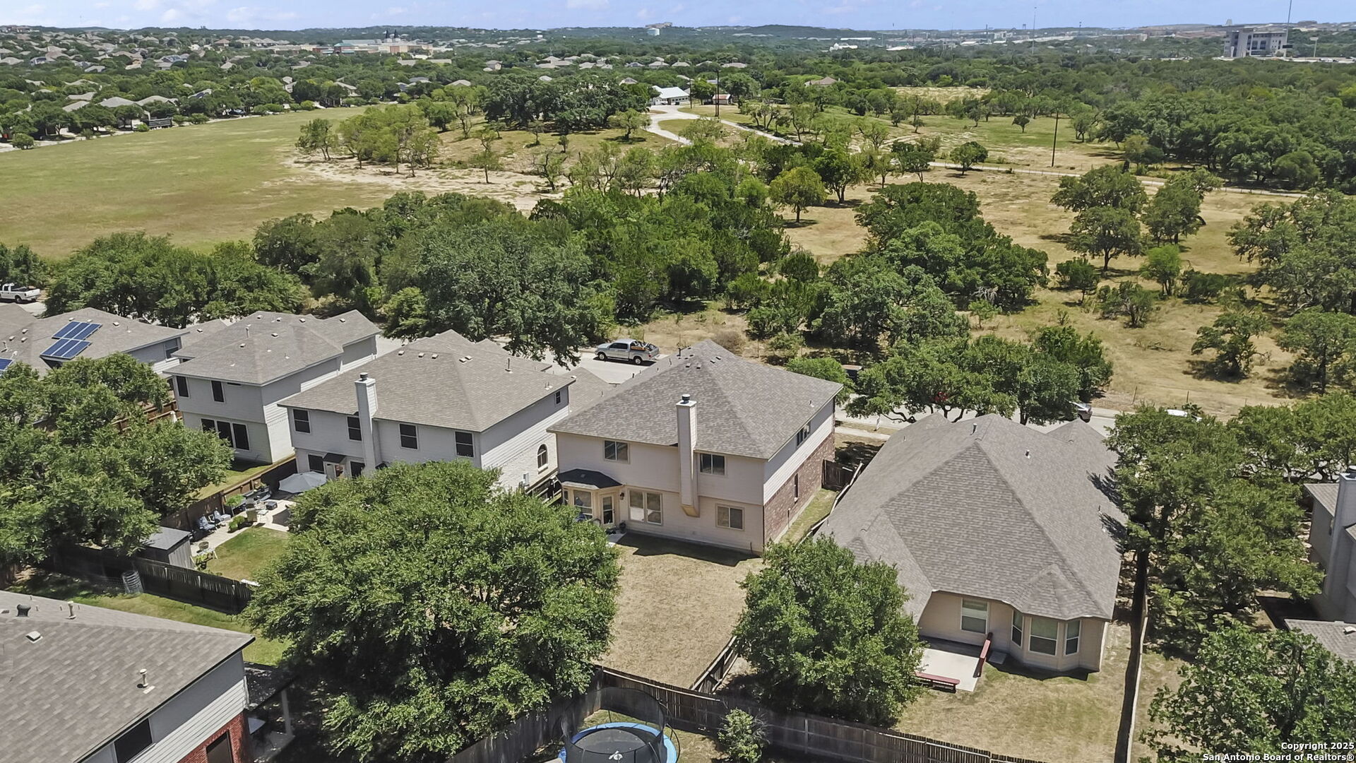 8747 Feather Trail Helotes, TX 78023 - Photo 2 of 34 an aerial view of residential houses with outdoor space and river