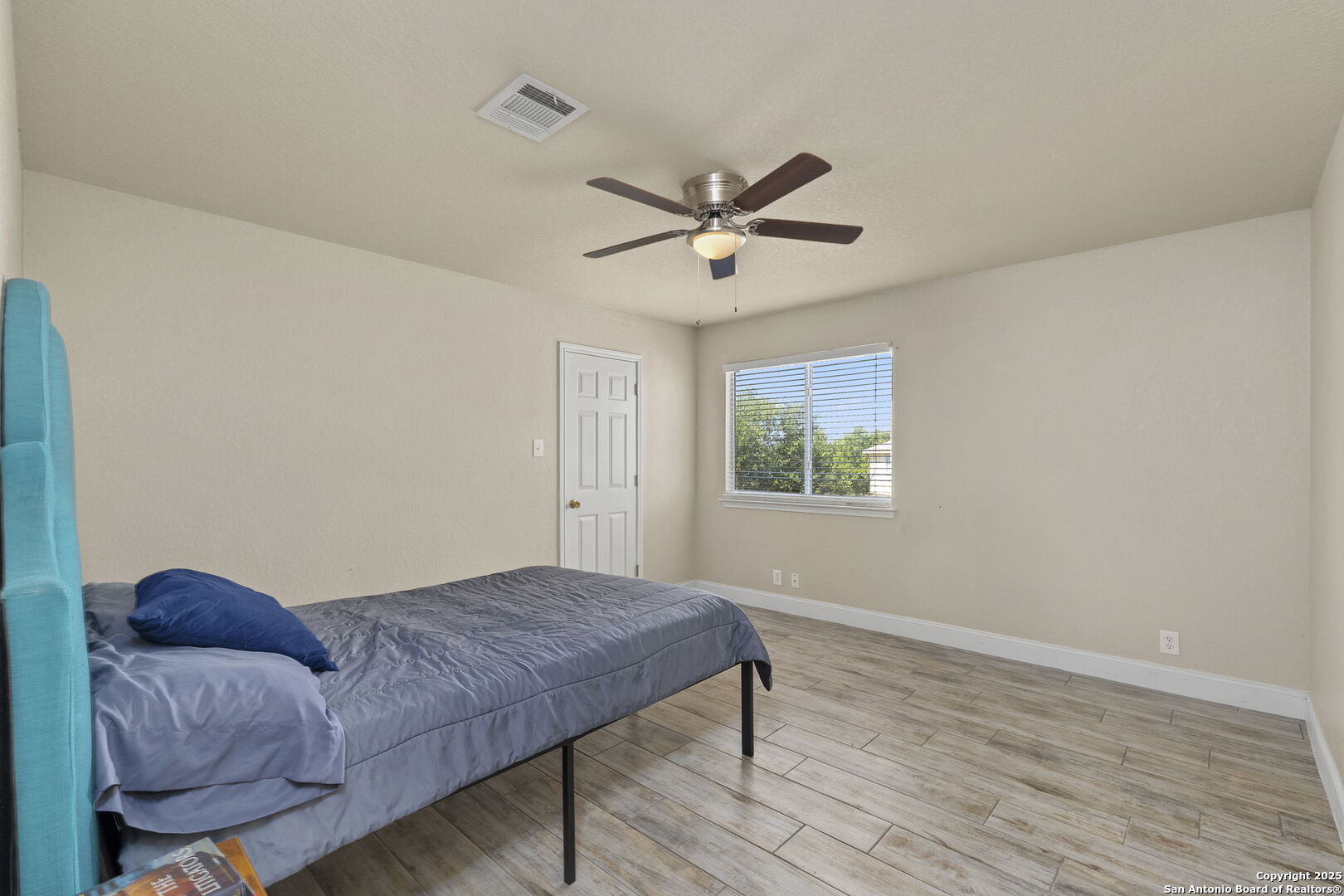 8747 Feather Trail Helotes, TX 78023 - Photo 22 of 34 a living room with a couch and a ceiling fan