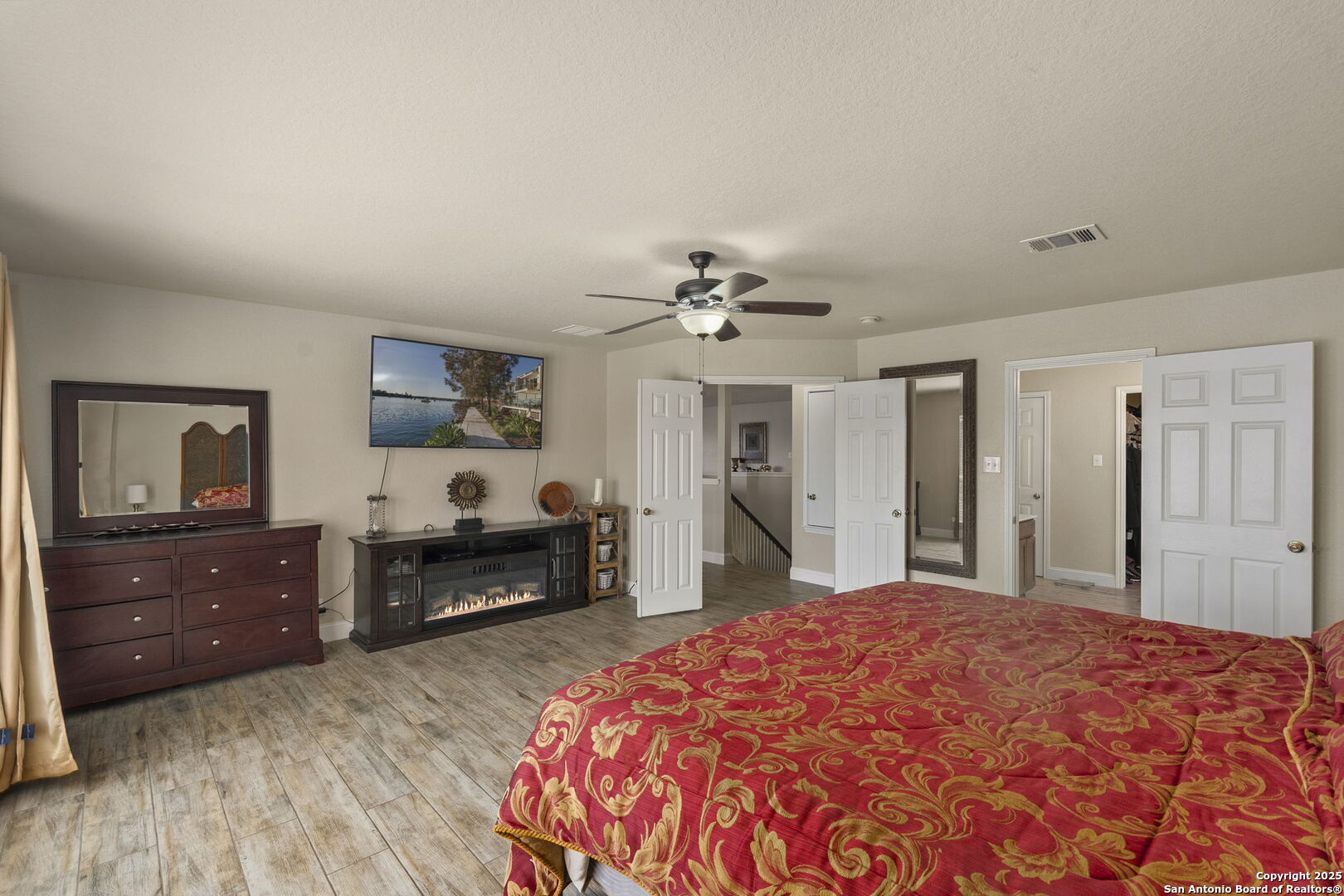 8747 Feather Trail Helotes, TX 78023 - Photo 24 of 34 a spacious bedroom with a bed and a dresser