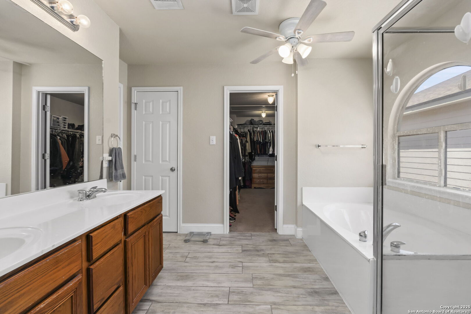 8747 Feather Trail Helotes, TX 78023 - Photo 25 of 34 a spacious bathroom with a tub shower and a sink