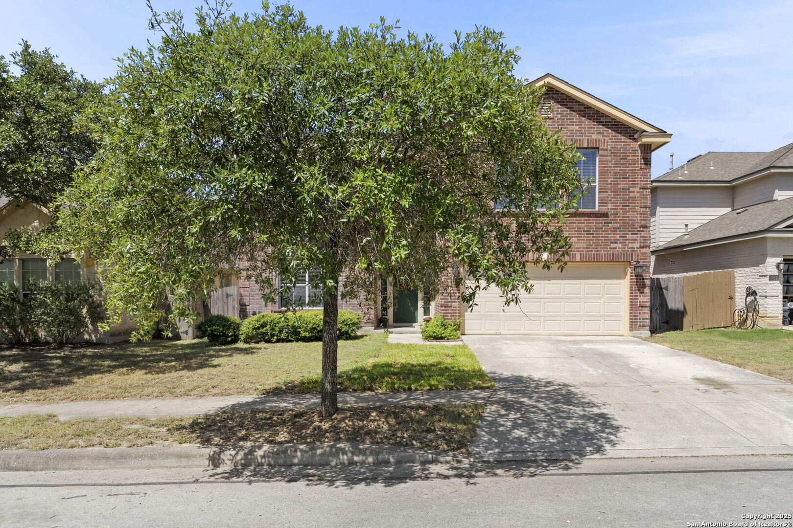8747 Feather Trail Helotes, TX 78023 - Photo 4 of 34 a front view of a house with a yard