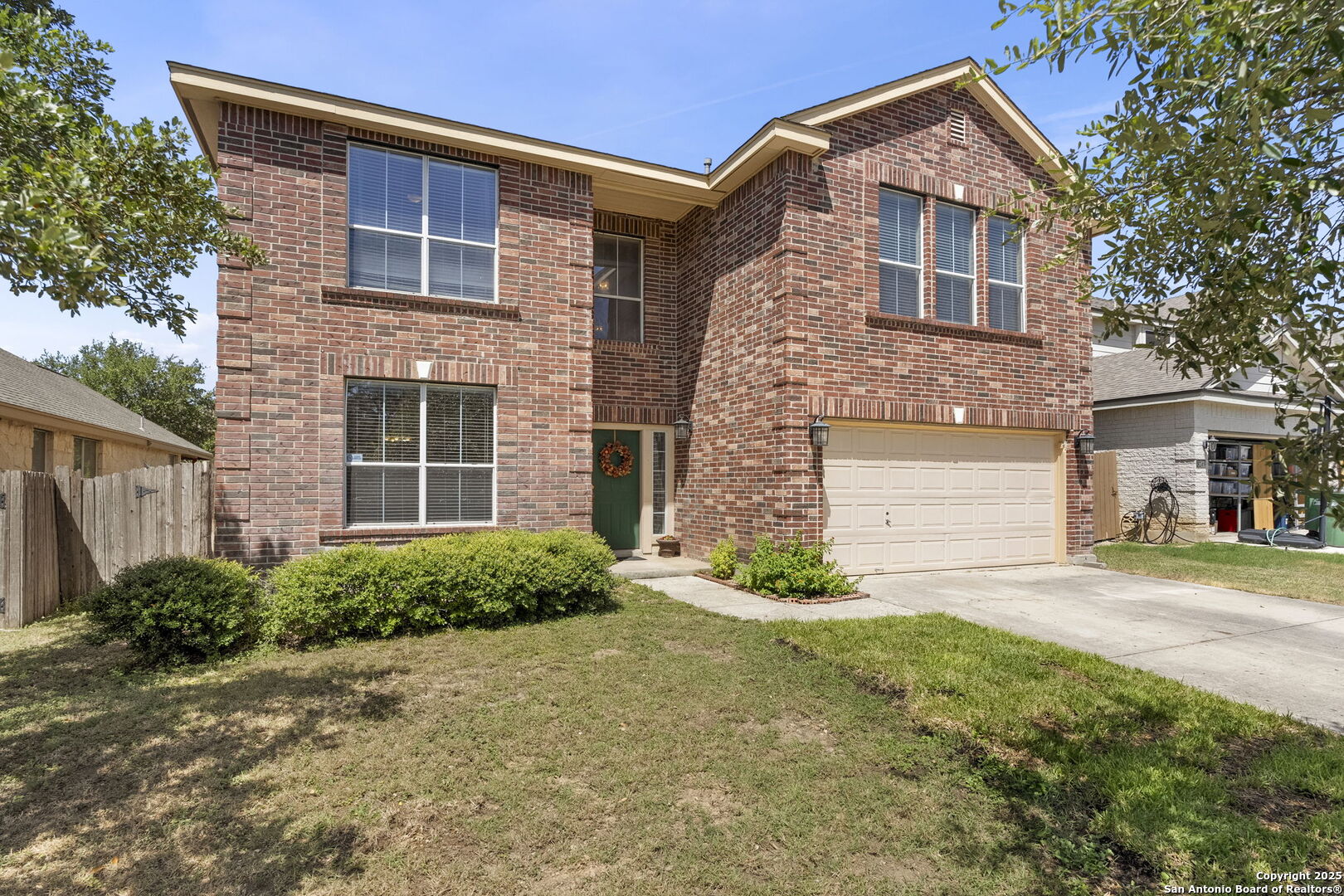 8747 Feather Trail Helotes, TX 78023 - Photo 5 of 34 a front view of a house with a yard and garage