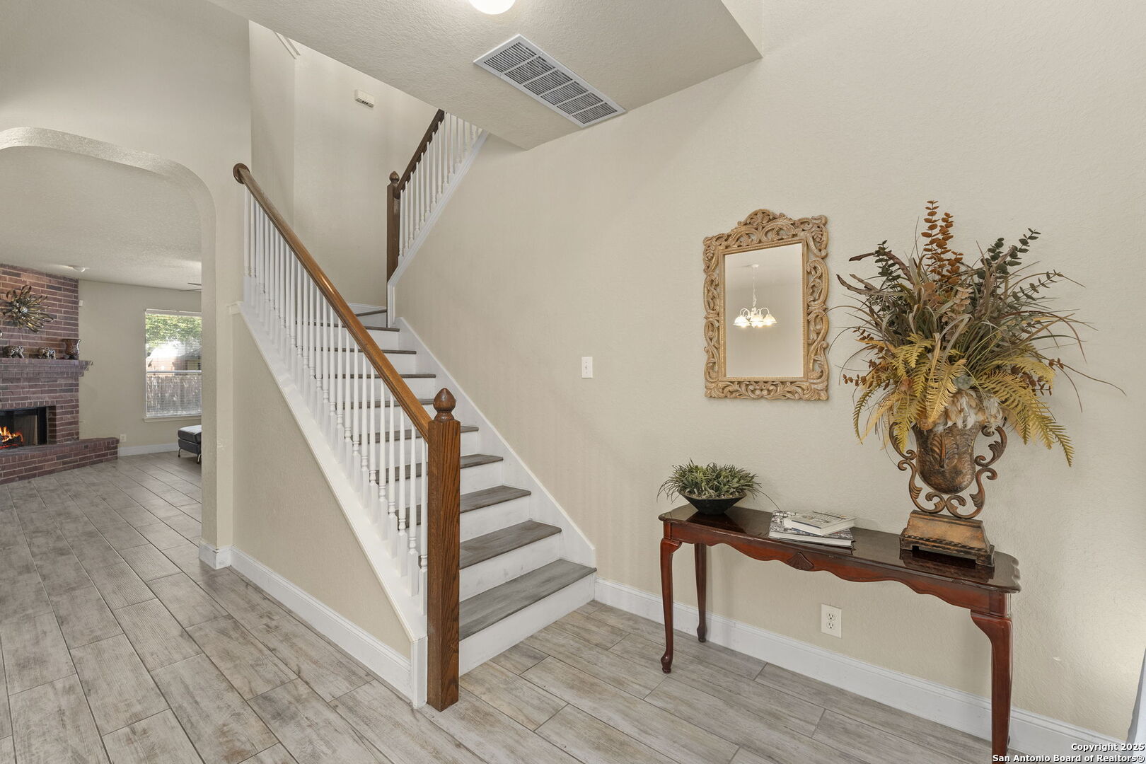 8747 Feather Trail Helotes, TX 78023 - Photo 7 of 34 a view of entryway and hall with wooden floor