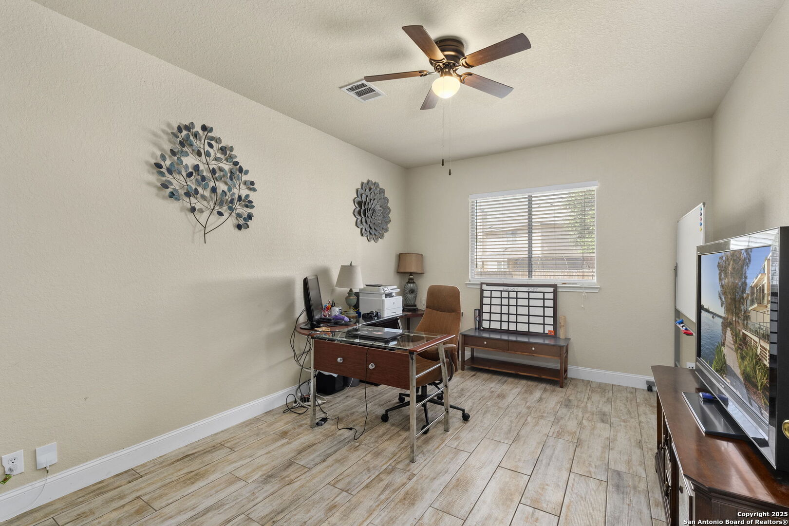 8747 Feather Trail Helotes, TX 78023 - Photo 10 of 34 a workspace with wooden floor and a window