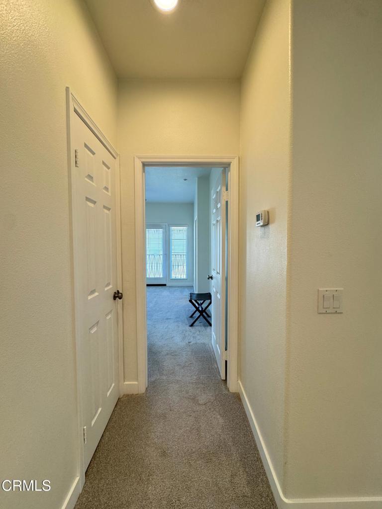 1232 Bayside Circle Oxnard, CA 93035 - Photo 27 of 48 a view of a hallway with wooden shelves