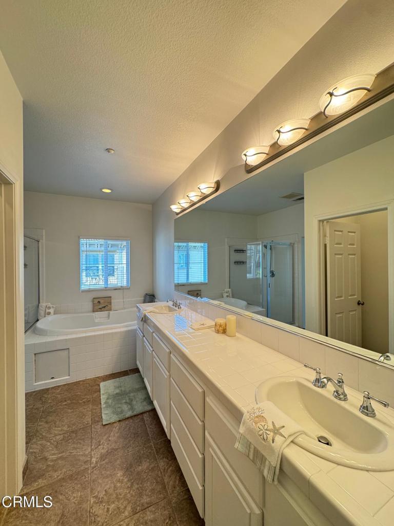 1232 Bayside Circle Oxnard, CA 93035 - Photo 33 of 48 a bathroom with a granite countertop sink mirror bathtub and toilet