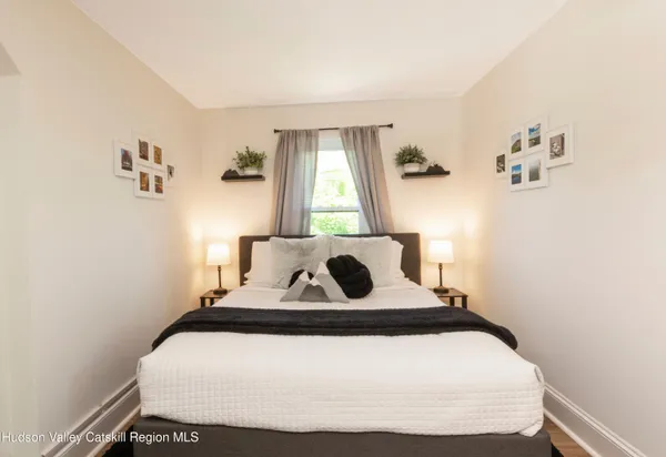 a bedroom with a bed and window