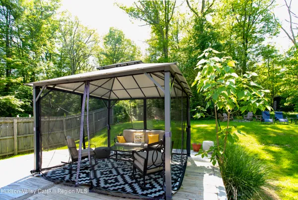 a view of swimming pool with a patio and a backyard