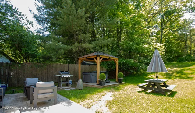 a view of a house with a yard patio and a slide