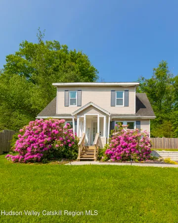 a front view of a house with a big yard
