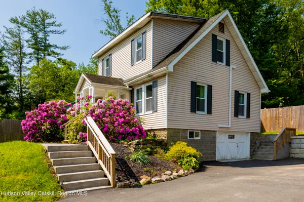 a front view of a house with a yard and outdoor seating