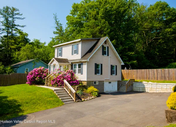 a view of a house with backyard and sitting area