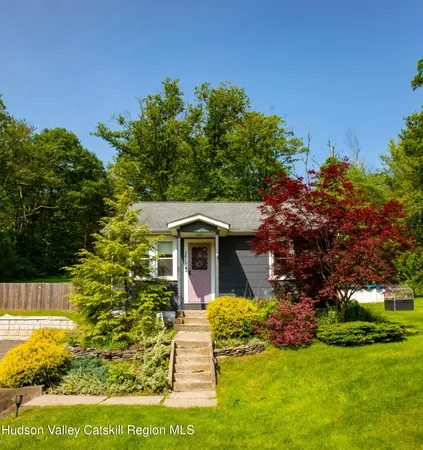 a view of house with a yard