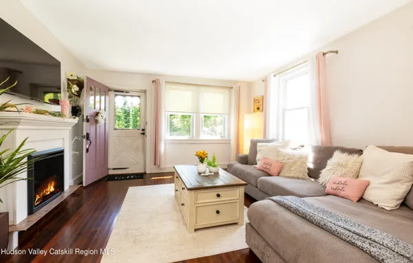 a living room with furniture a fireplace and flat screen tv