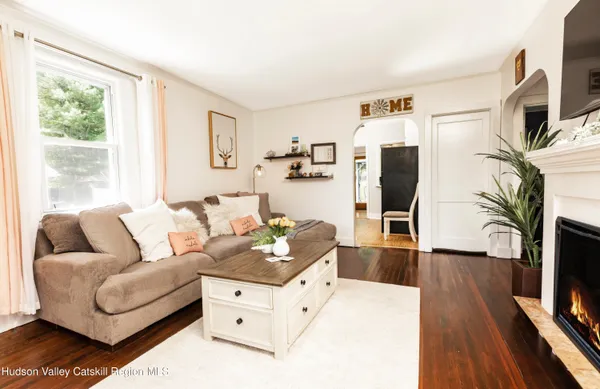 a living room with furniture fireplace and flat screen tv